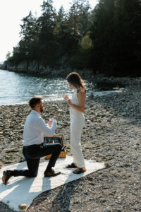 Man is proposing to woman at the beach
