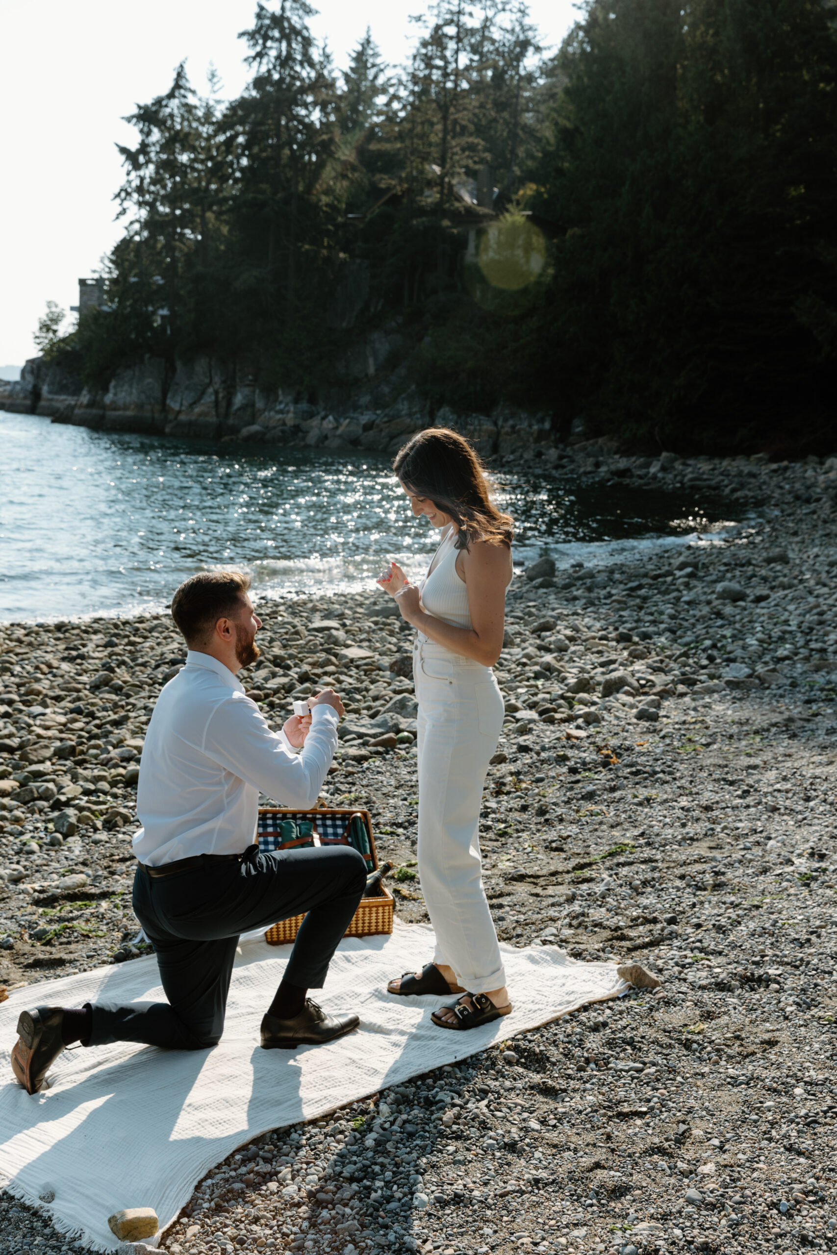 Man is proposing to woman at the beach