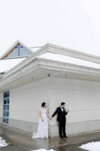 wedding groom and bride holding hands reading letters to each other