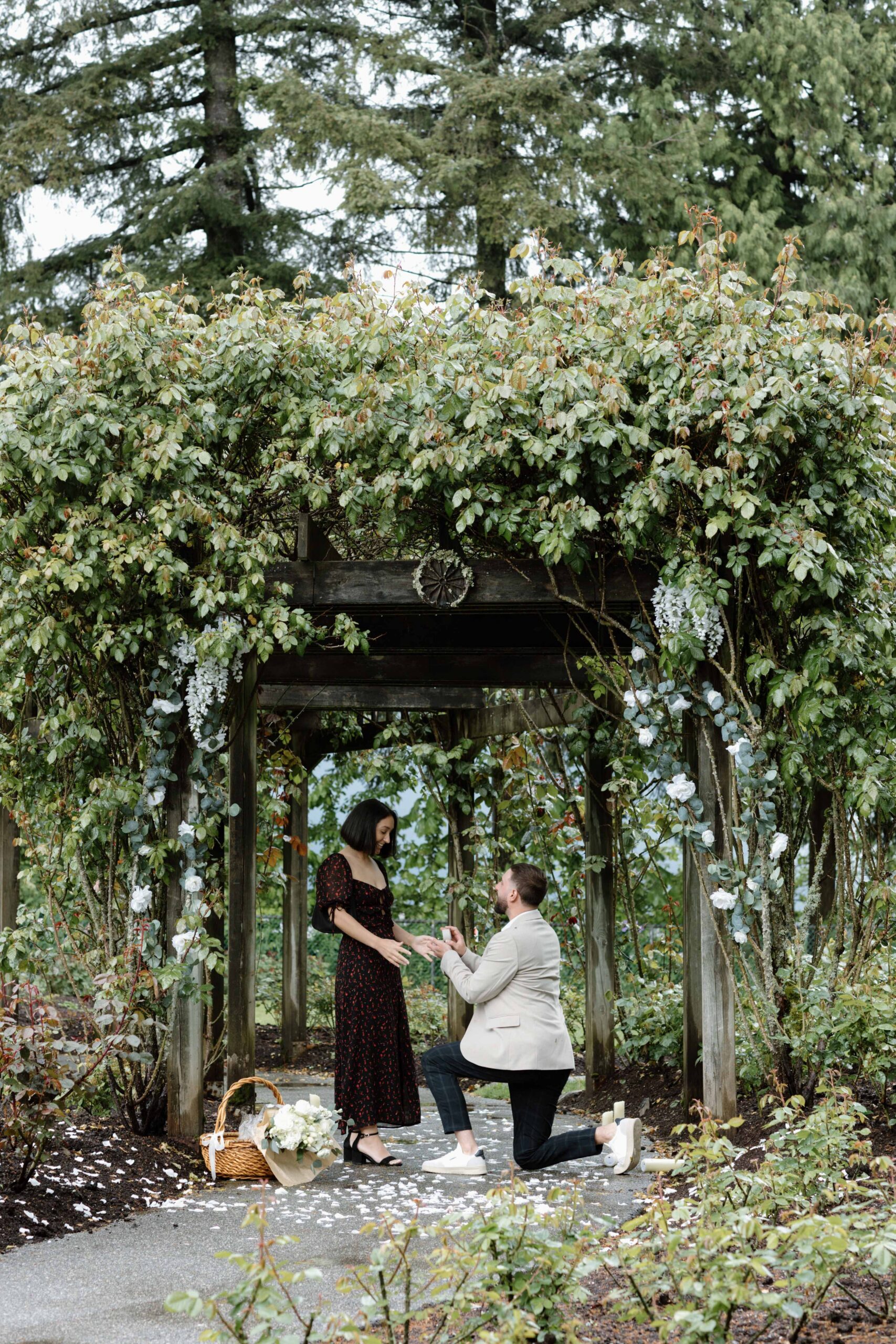 man proposes to woman under arch
